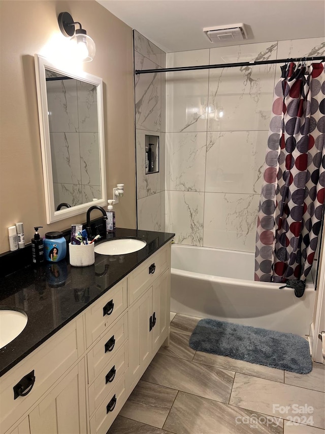 bathroom featuring vanity and shower / bathtub combination with curtain