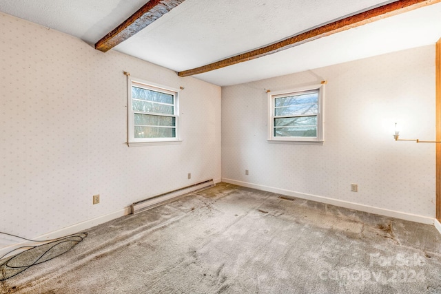 spare room featuring baseboard heating, a healthy amount of sunlight, carpet floors, and beamed ceiling