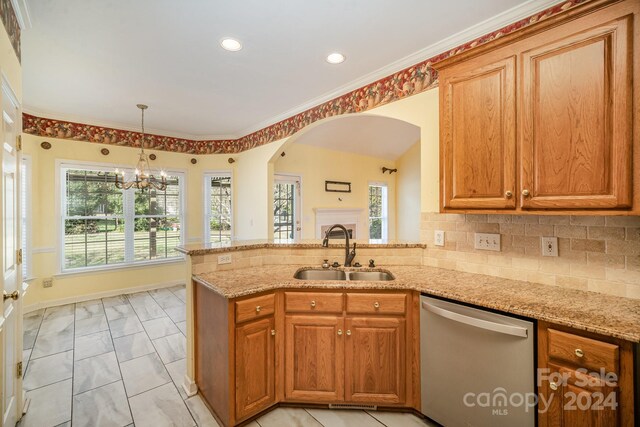 kitchen with a healthy amount of sunlight, kitchen peninsula, a chandelier, sink, and stainless steel dishwasher