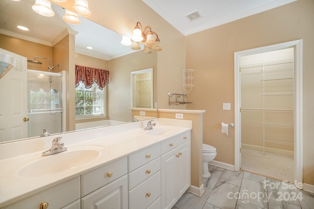 bathroom featuring a shower with shower door, vanity, toilet, and crown molding