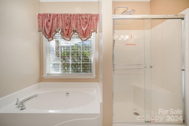 bathroom featuring separate shower and tub