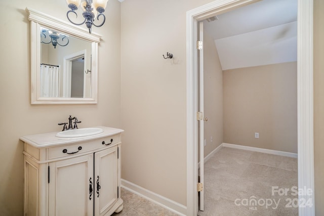 bathroom featuring vanity and vaulted ceiling