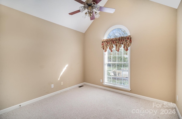 empty room featuring vaulted ceiling, ceiling fan, and carpet floors