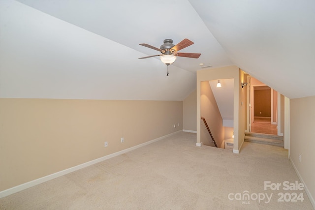 additional living space with ceiling fan, light carpet, and lofted ceiling