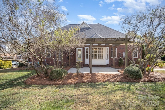 rear view of property featuring a lawn and a patio