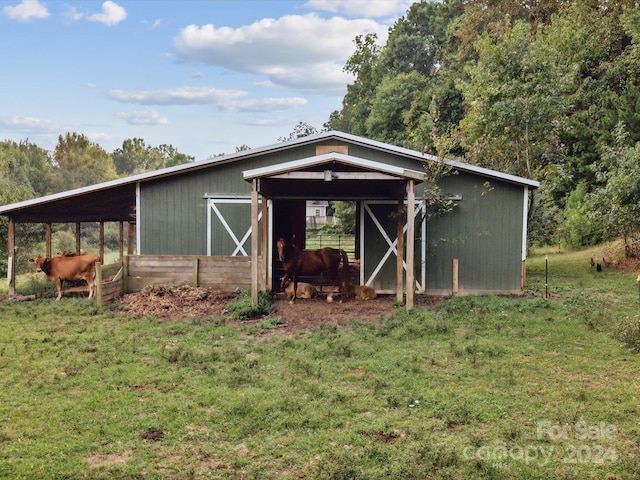 view of outdoor structure featuring a lawn