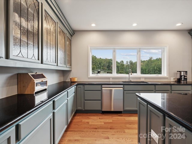 kitchen with dishwasher, sink, a healthy amount of sunlight, and light hardwood / wood-style flooring