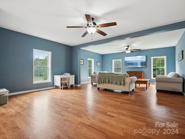 bedroom with multiple windows and light wood-type flooring