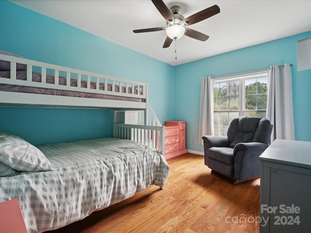 bedroom featuring hardwood / wood-style floors and ceiling fan