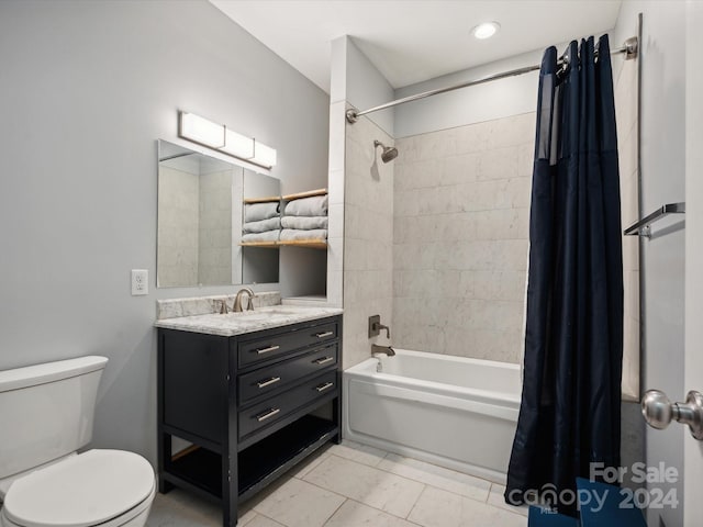 full bathroom with vanity, shower / bath combo, and toilet