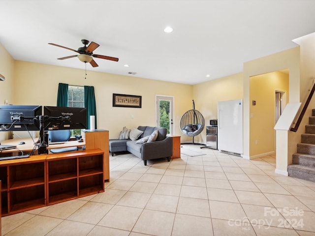 living room featuring light tile patterned flooring and ceiling fan