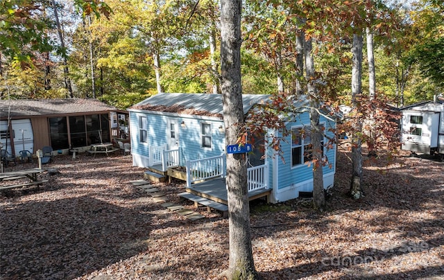 view of outdoor structure featuring a sunroom