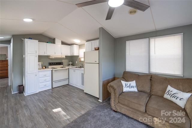 kitchen featuring lofted ceiling, hardwood / wood-style flooring, sink, white cabinetry, and white appliances