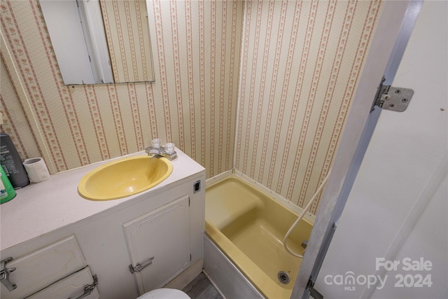 bathroom featuring a tub to relax in and vanity