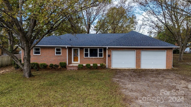 single story home featuring a garage and a front yard