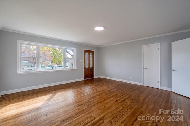 interior space with hardwood / wood-style floors and ornamental molding