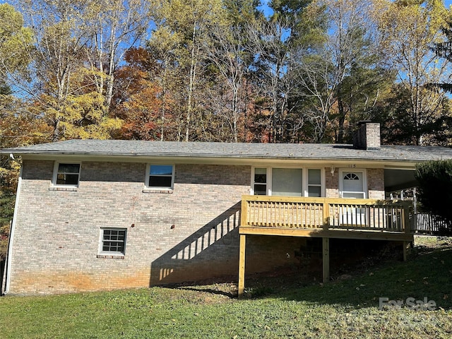 back of house with a yard and a deck