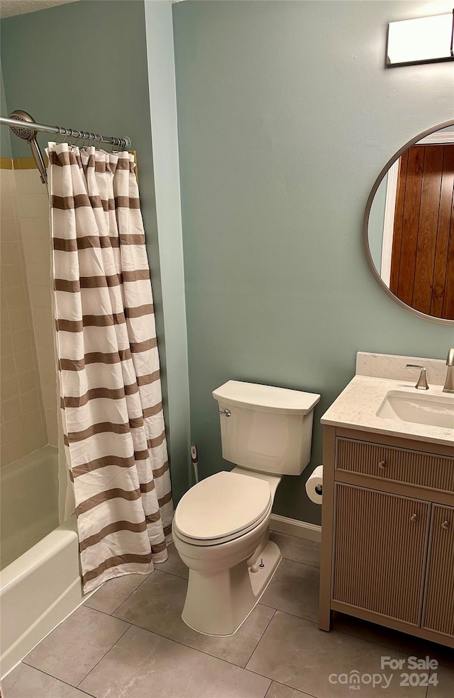 full bathroom with vanity, tile patterned floors, toilet, and shower / bath combination with curtain