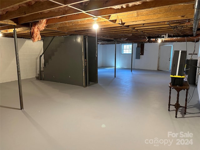 basement with electric panel and water heater