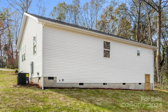 view of home's exterior featuring central AC and a yard