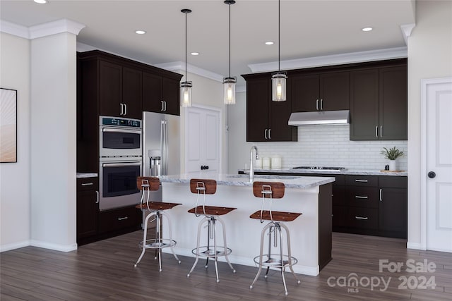 kitchen with a center island with sink, a breakfast bar area, appliances with stainless steel finishes, and dark wood-type flooring