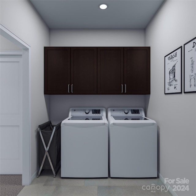 laundry area with separate washer and dryer and cabinets