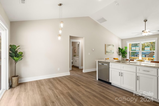 kitchen featuring stainless steel dishwasher, lofted ceiling, white cabinetry, and hardwood / wood-style floors