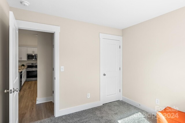 unfurnished bedroom featuring hardwood / wood-style flooring and a closet