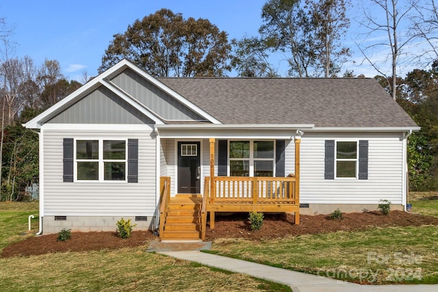 109 Orchard St, Forest City, NC 28043 - view of front of home featuring crawl space, covered porch, a front yard, and a shingled roof