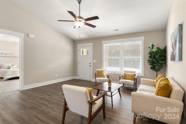 living room with ceiling fan, dark hardwood / wood-style floors, and vaulted ceiling