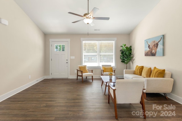 living room with ceiling fan and dark wood-type flooring