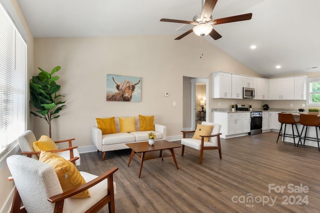 living room featuring ceiling fan, a healthy amount of sunlight, lofted ceiling, and dark wood-type flooring