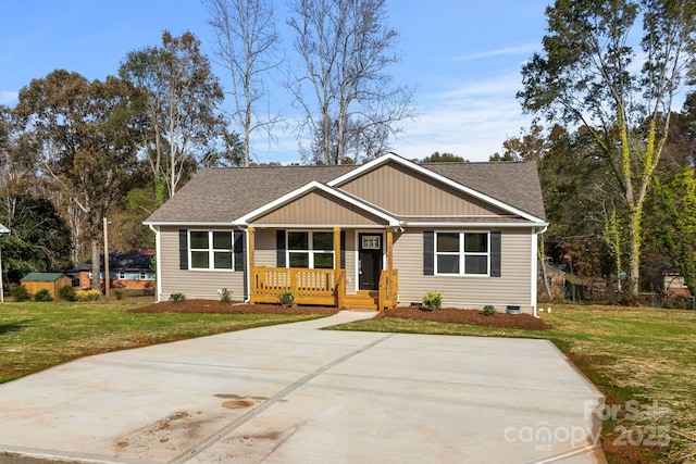121 Orchard St, Forest City, NC 28043 - view of front facade featuring a shingled roof, a porch, a front lawn, and crawl space