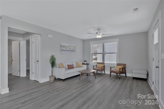 living room featuring hardwood / wood-style floors and ceiling fan