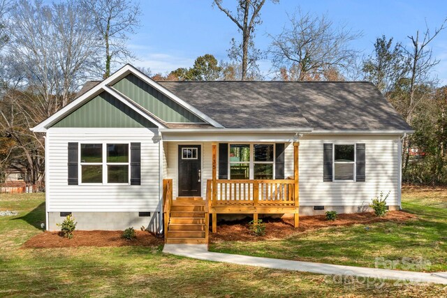 135 Orchard St, Forest City, NC 28043 - view of front of house with covered porch, crawl space, board and batten siding, and a front yard