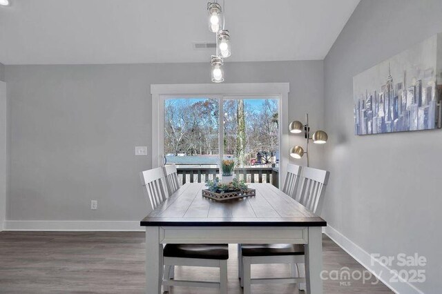 135 Orchard St, Forest City, NC 28043 - dining room with baseboards, visible vents, and wood finished floors