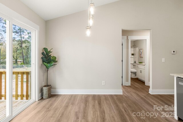 135 Orchard St, Forest City, NC 28043 - unfurnished dining area featuring baseboards and wood finished floors