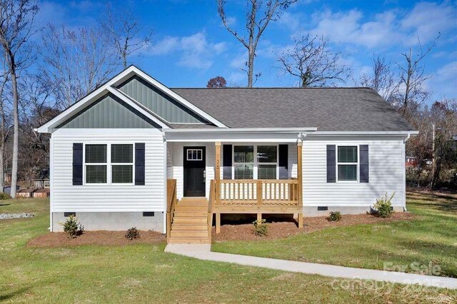 135 Orchard St, Forest City, NC 28043 - view of front of house featuring a porch, a front yard, and crawl space