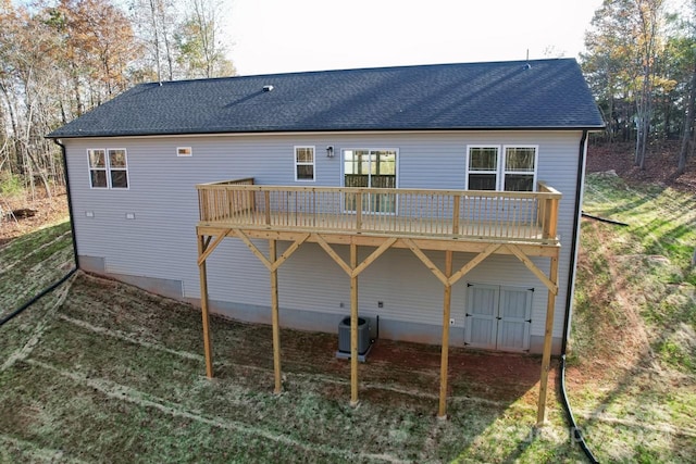 rear view of property with central air condition unit and a wooden deck