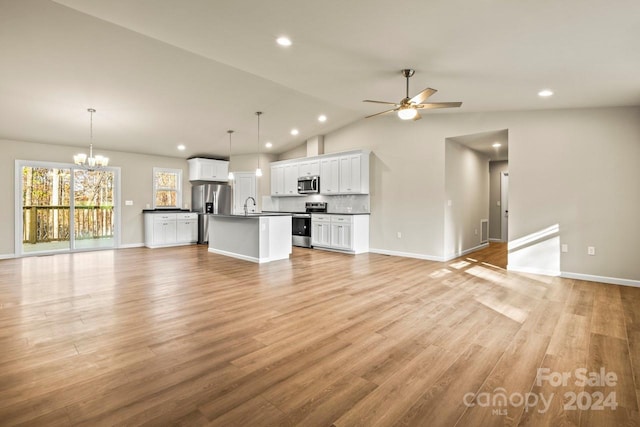 unfurnished living room with ceiling fan with notable chandelier, light hardwood / wood-style flooring, vaulted ceiling, and sink