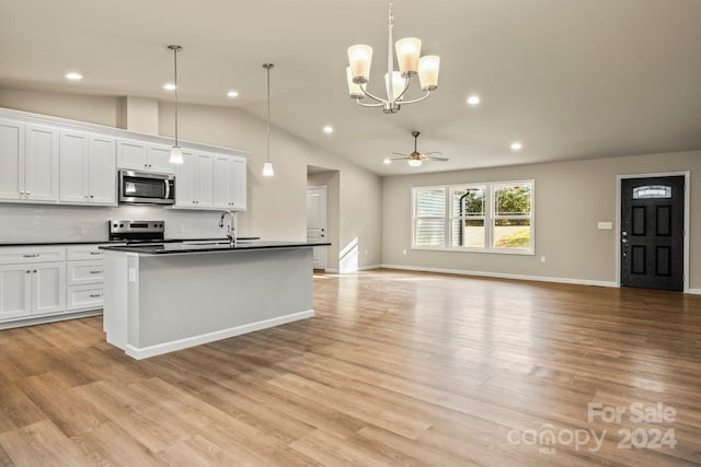 kitchen featuring white cabinets, ceiling fan with notable chandelier, lofted ceiling, and stainless steel appliances