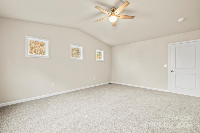 spare room with carpet flooring, ceiling fan, and lofted ceiling