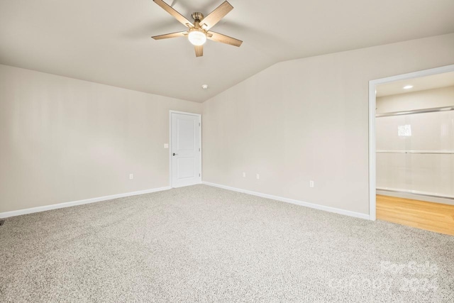 empty room with carpet flooring, ceiling fan, and lofted ceiling