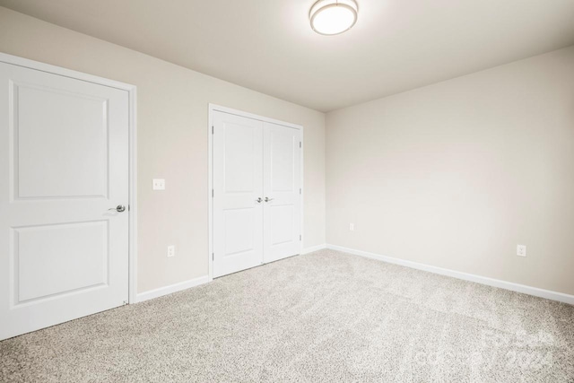 unfurnished bedroom with a closet and carpet