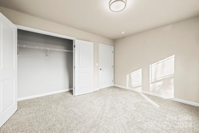 unfurnished bedroom featuring carpet flooring and a closet