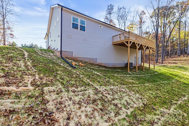 back of house with a lawn, central AC unit, and a wooden deck