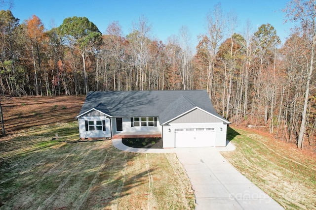 ranch-style home with a garage and a front yard