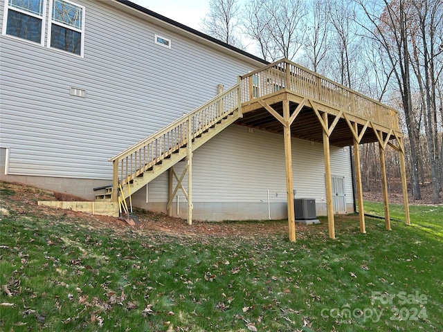 view of side of property with cooling unit, a yard, and a wooden deck