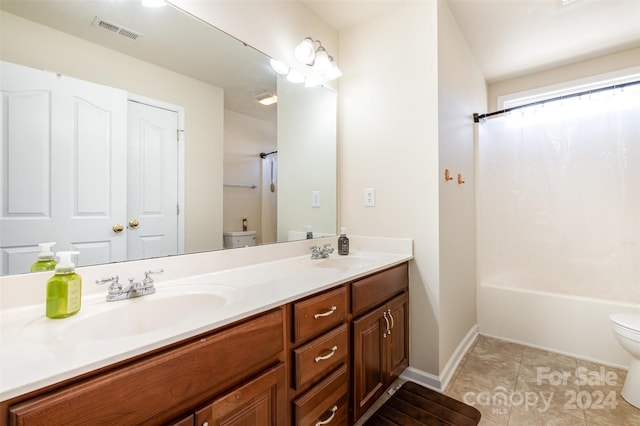 full bathroom featuring tile patterned flooring, vanity, toilet, and shower / tub combo