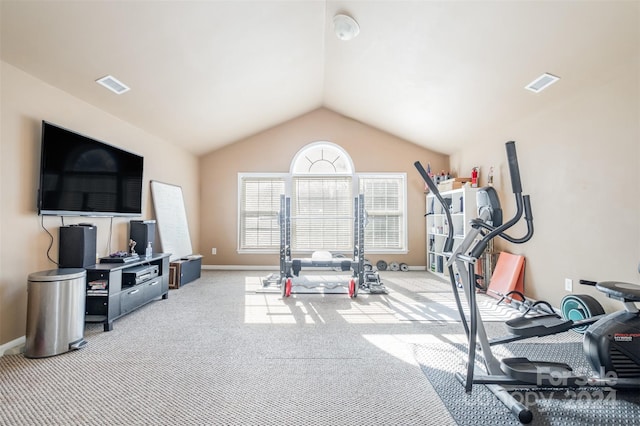 workout area featuring light colored carpet and vaulted ceiling